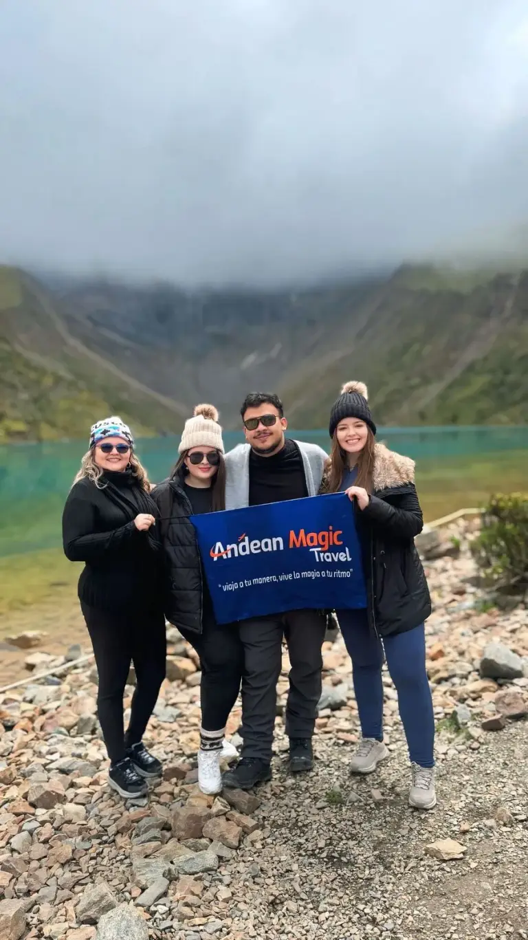 Group with the Andean Magic Travel flag at Humantay Lake