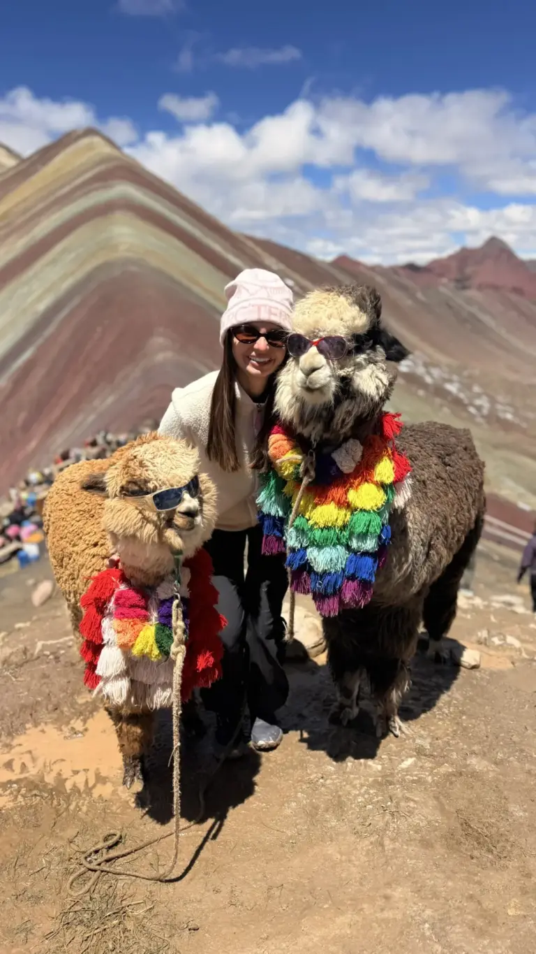 Traveller with alpacas at Rainbow Mountain