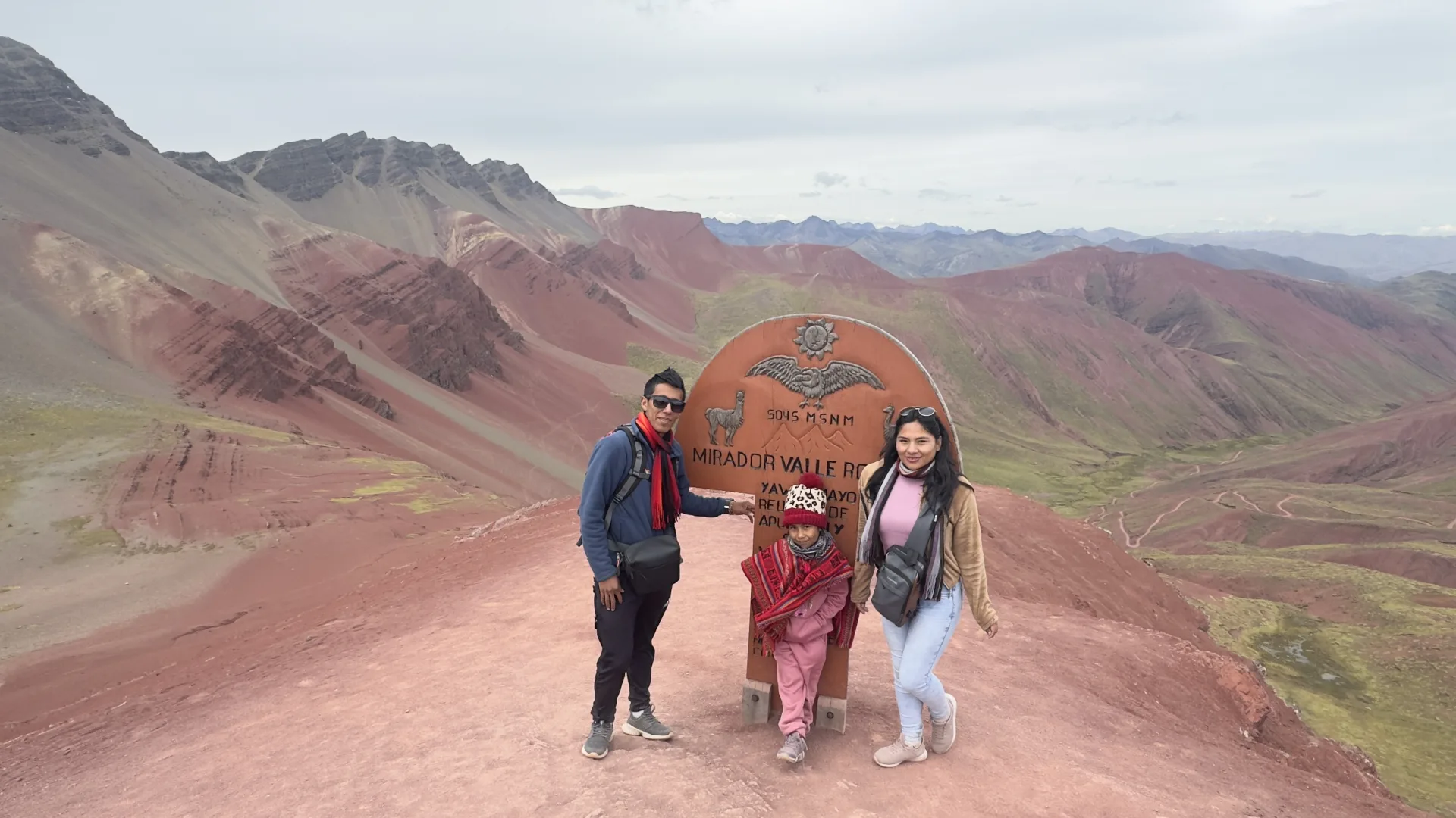 Family at the summit of Vinicunca Rainbow Mountain