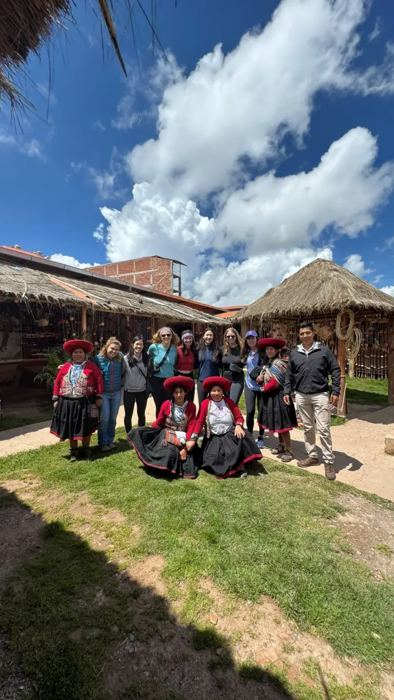 Group of travellers with the Chinchero weavers in the textile centre courtyard