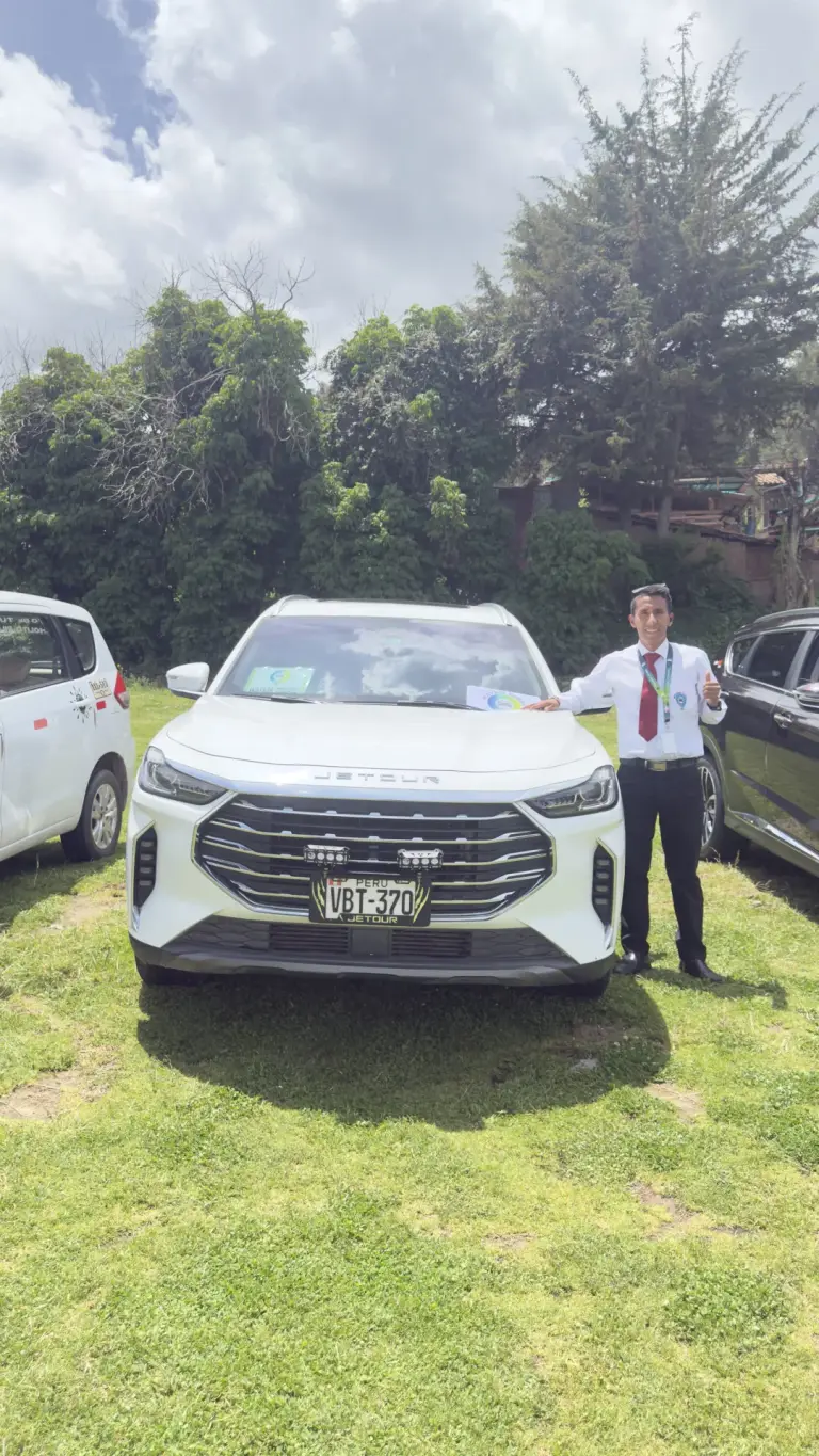 Andean Magic Travel driver next to a white SUV, front view