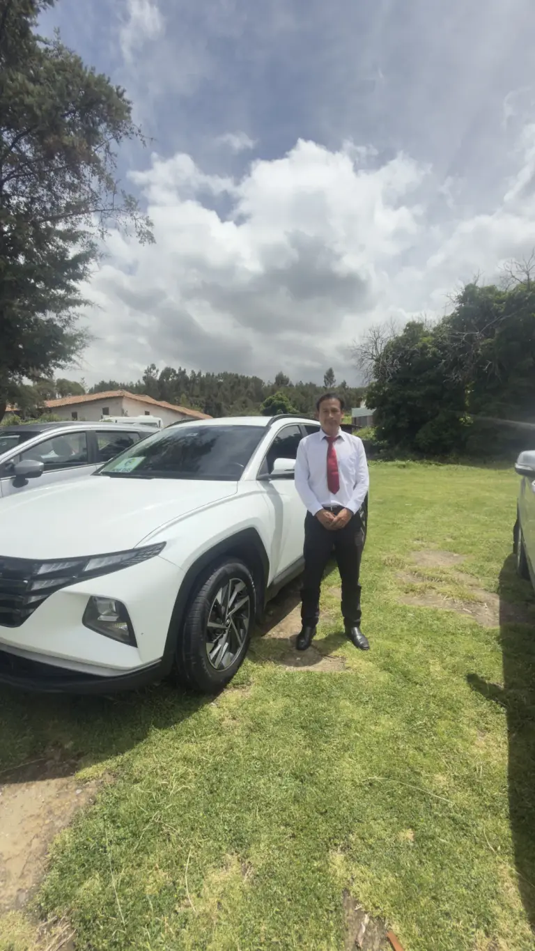 Andean Magic Travel driver next to a white SUV
