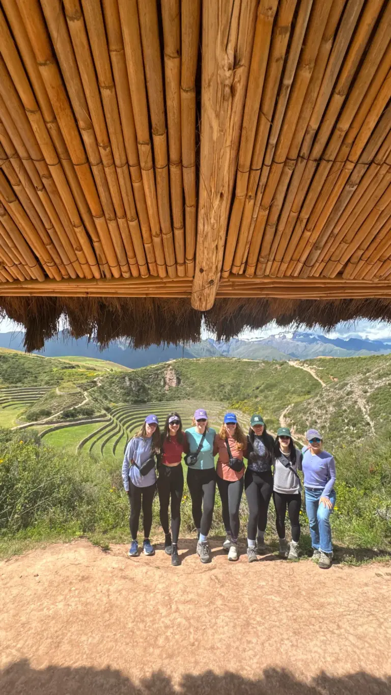 Group of travellers at the viewpoint above the circular terraces of Moray